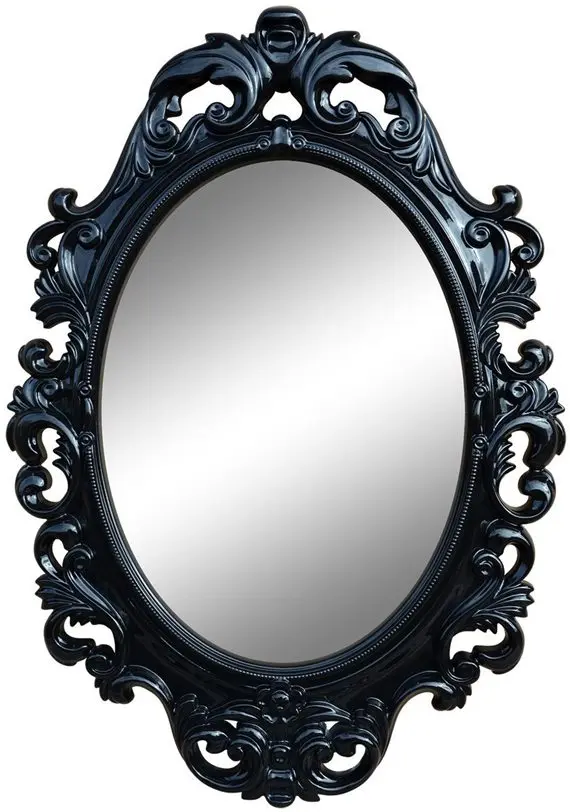 Черное зеркало, помещенное в латунный наличник с коваными узорами